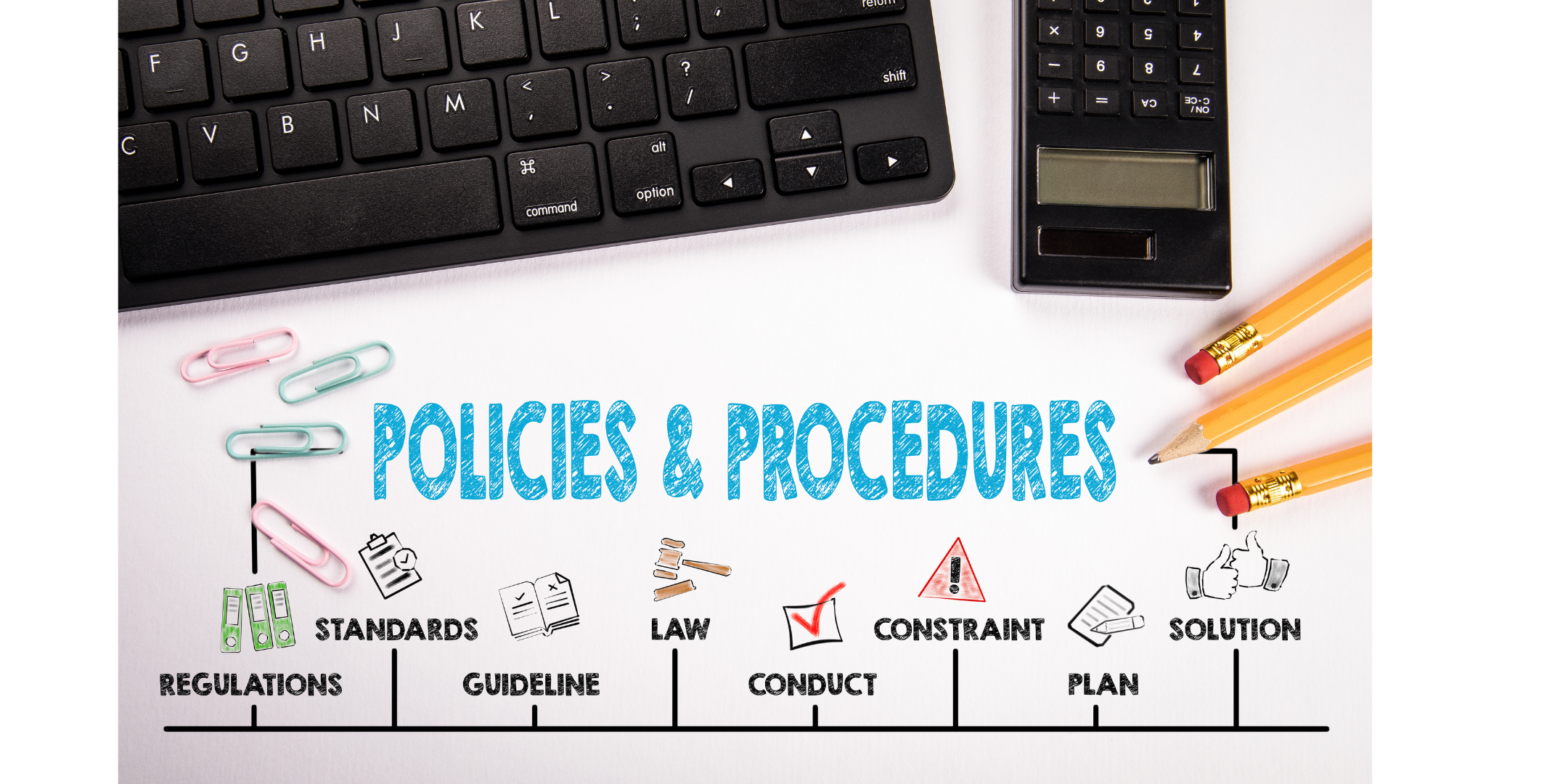 a keyboard and calculator on a white desk. There is writing on the desk. Policies and procedures. regulations. standards. guideline. law. conduct. constraint. plan. solution